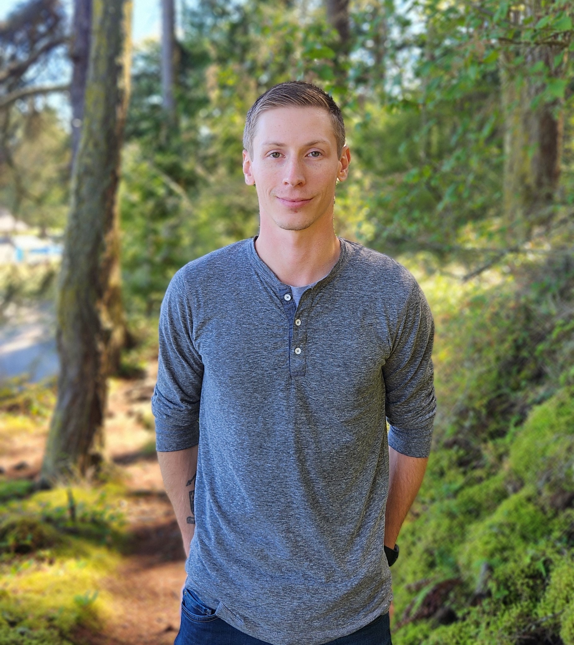 sam in a forest looking to the camera